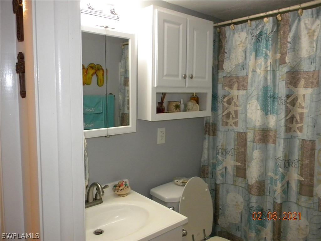 2121 Collier Avenue, Unit 102 Fort Myers, FL 33901 - Photo 18 of 28 a bathroom with a sink and mirror with toilet