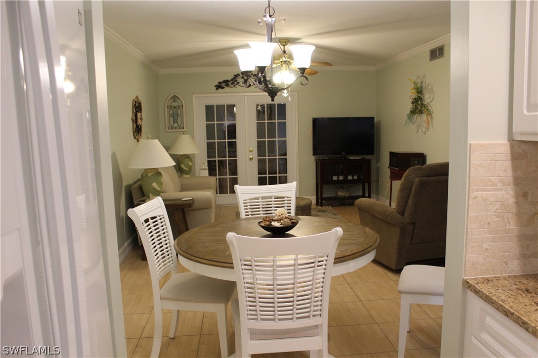 2121 Collier Avenue, Unit 102 Fort Myers, FL 33901 - Photo 2 of 28 a dining room with furniture and wooden floor