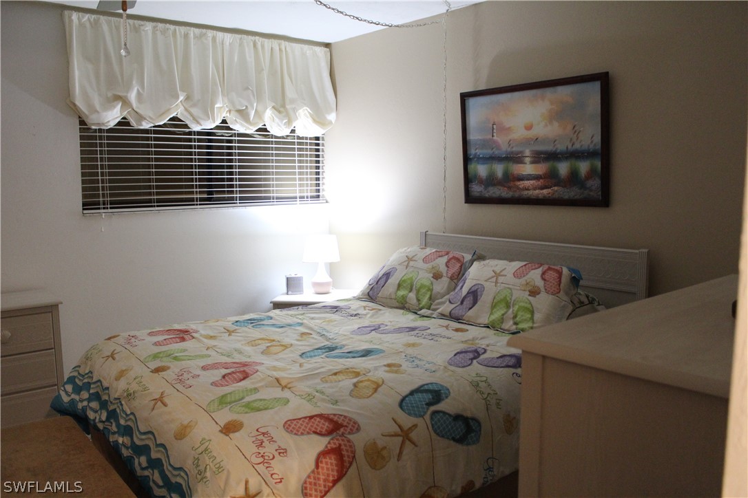 2121 Collier Avenue, Unit 102 Fort Myers, FL 33901 - Photo 27 of 28 a bedroom with a bed and a window