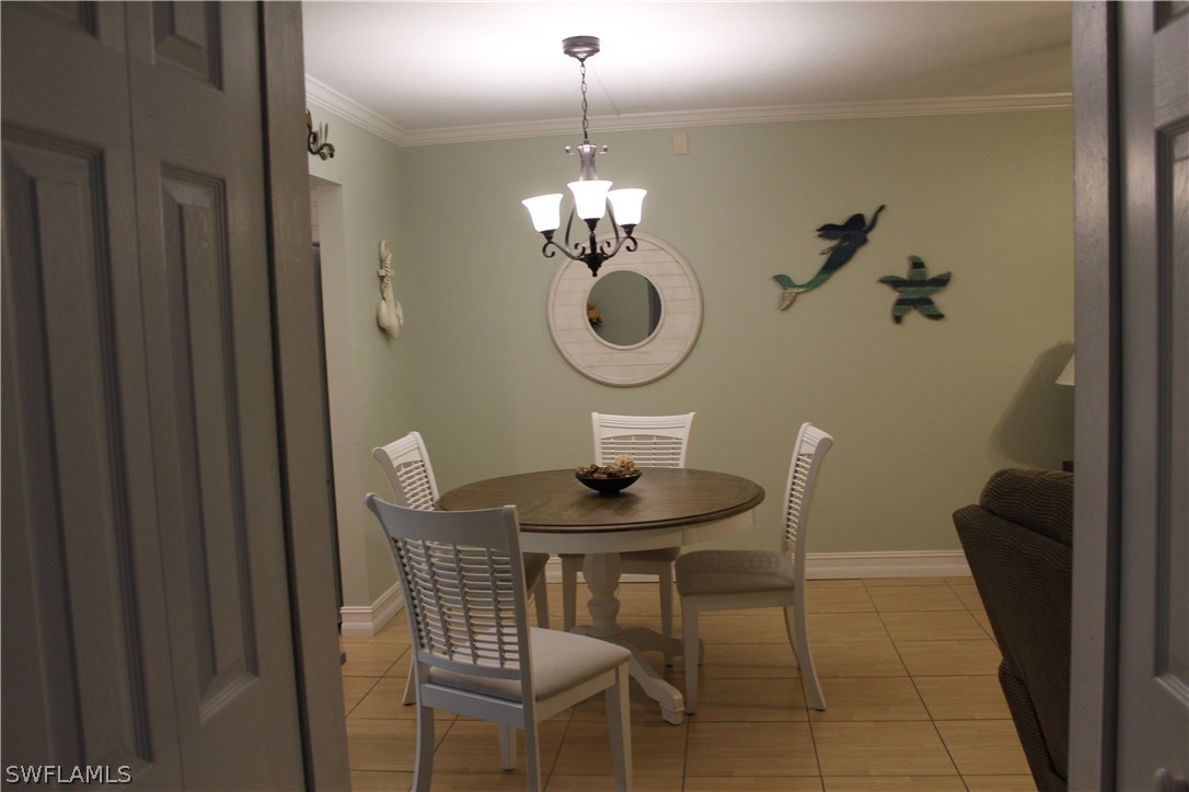 2121 Collier Avenue, Unit 102 Fort Myers, FL 33901 - Photo 4 of 28 a dining room with table chairs and wooden floor