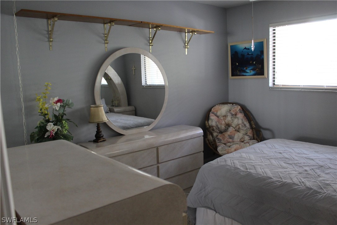 2121 Collier Avenue, Unit 102 Fort Myers, FL 33901 - Photo 7 of 28 a bedroom with bed and a potted plant