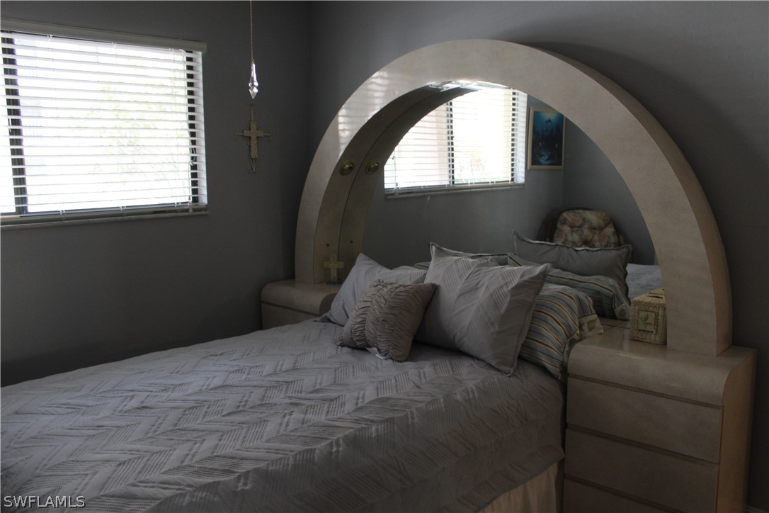 2121 Collier Avenue, Unit 102 Fort Myers, FL 33901 - Photo 9 of 28 a bedroom with a bed and a window