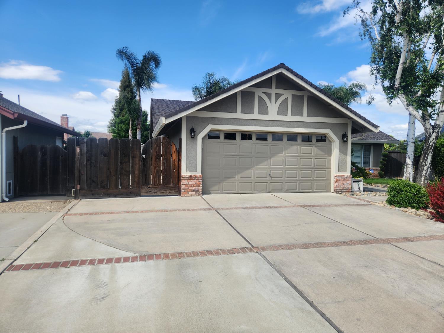 777 Jordanolo Drive Ripon, CA 95366 - Photo 2 of 61 a front view of a house with a yard and garage