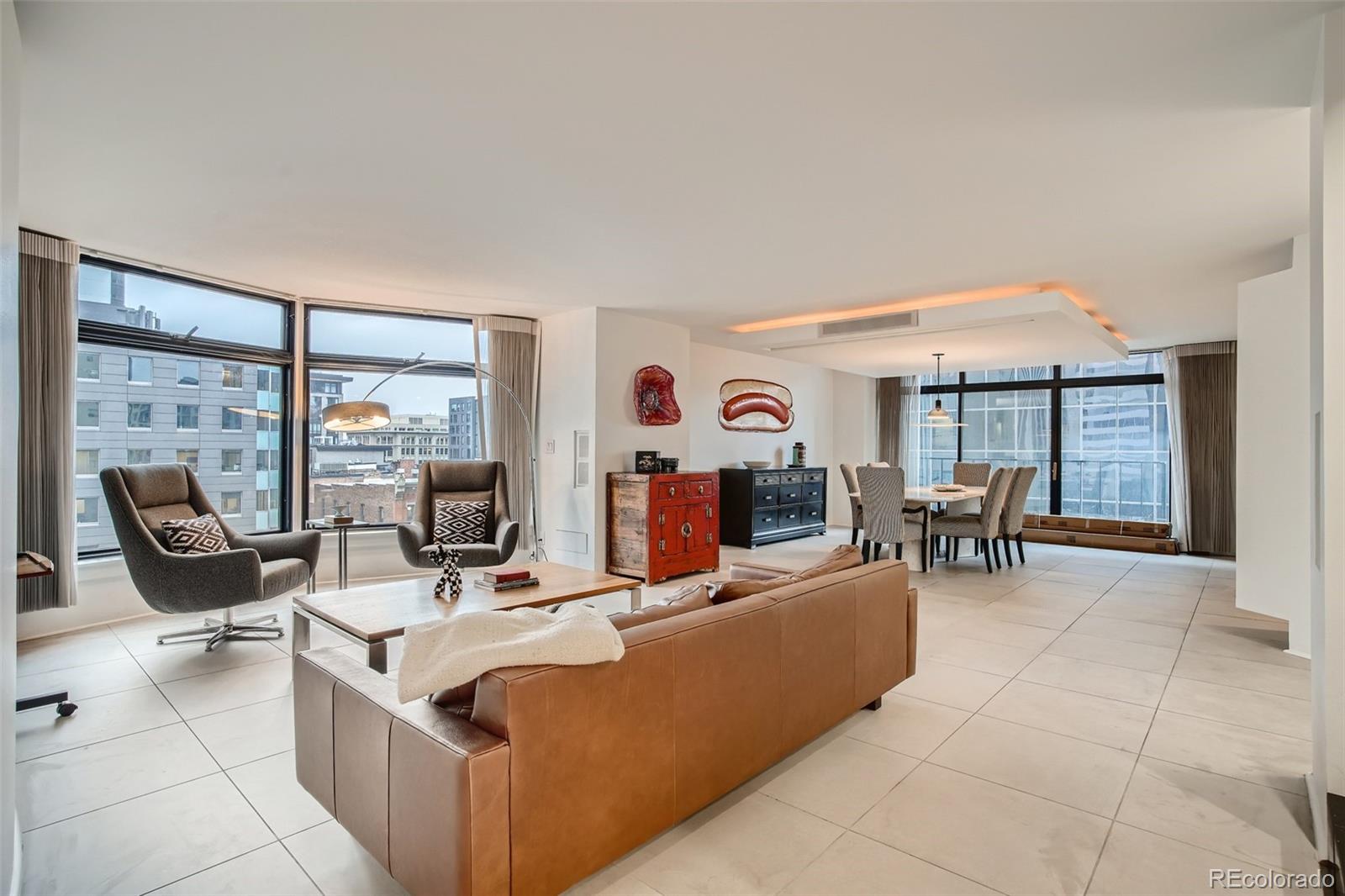 a living room with furniture and large windows
