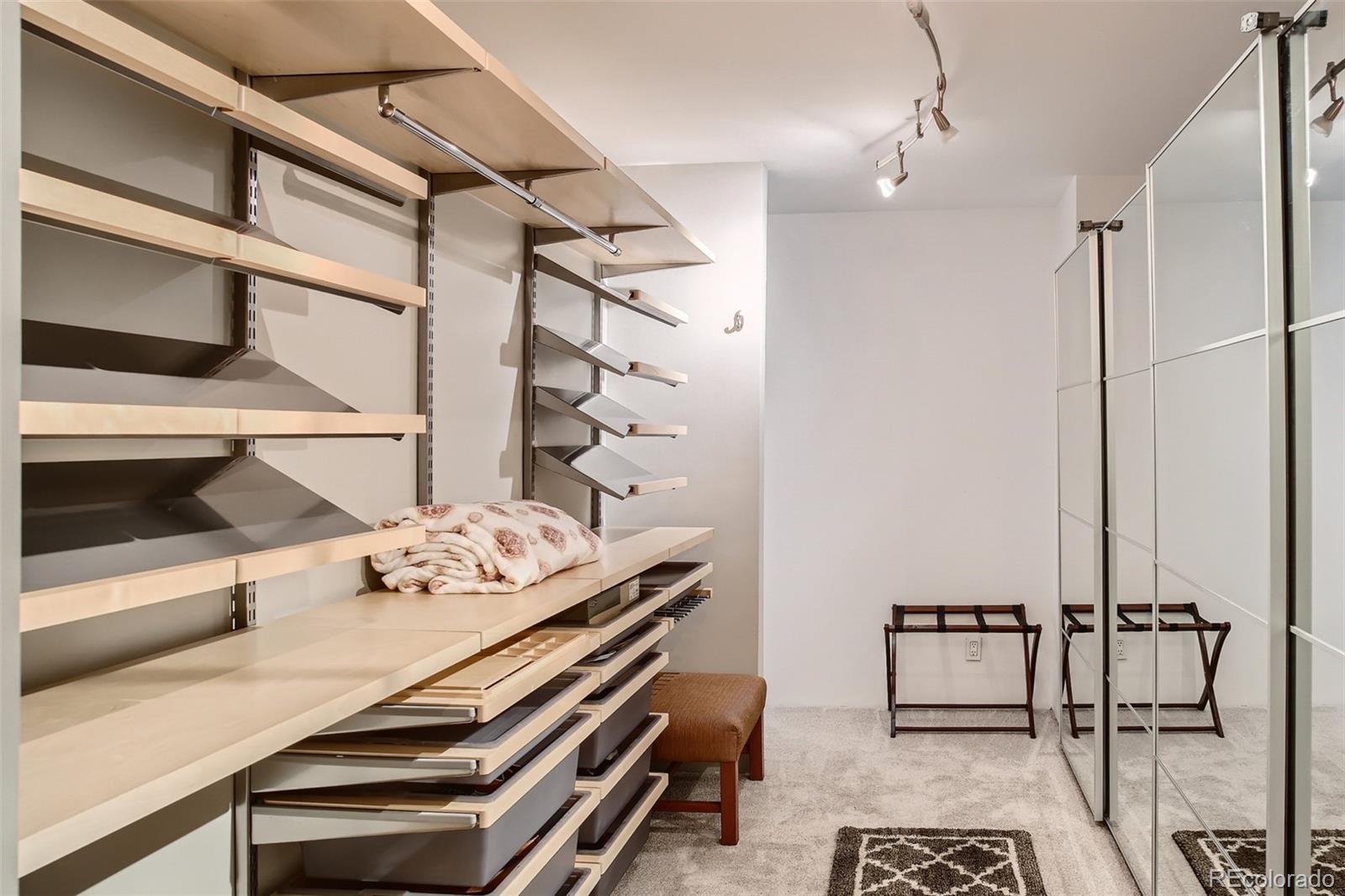 1777 Larimer Street, Unit 710 Denver, CO 80202 - Photo 14 of 28 a bedroom with a bed and a dresser