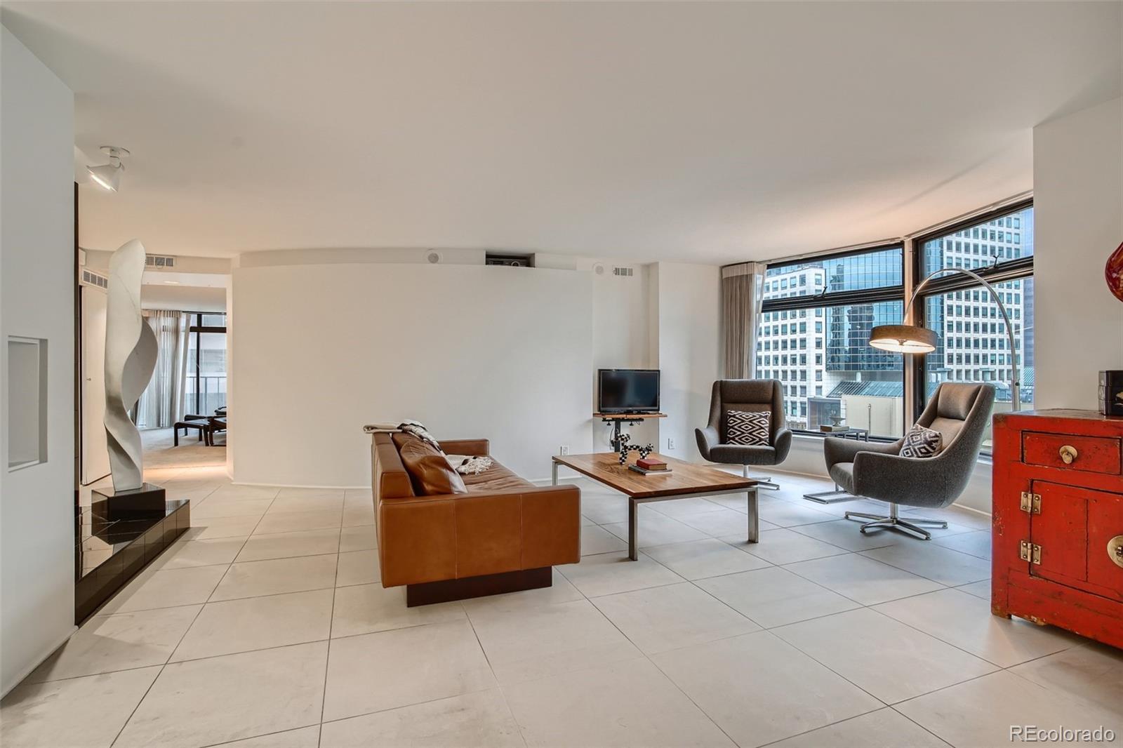 1777 Larimer Street, Unit 710 Denver, CO 80202 - Photo 8 of 28 a living room with furniture and a flat screen tv