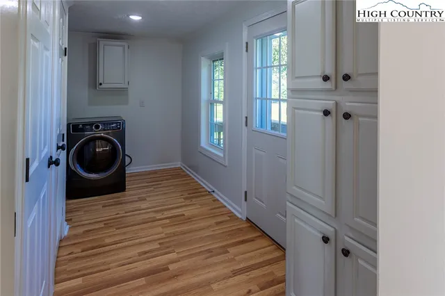 a view of a hallway with washer and dryer
