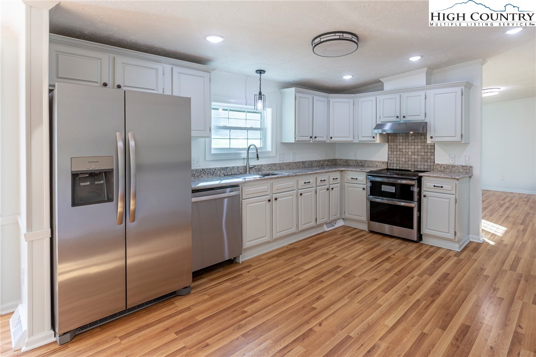 101 Beau Rivage Drive Crumpler, NC 28617 - Photo 15 of 47 a kitchen with stainless steel appliances granite countertop a stove a sink and a refrigerator