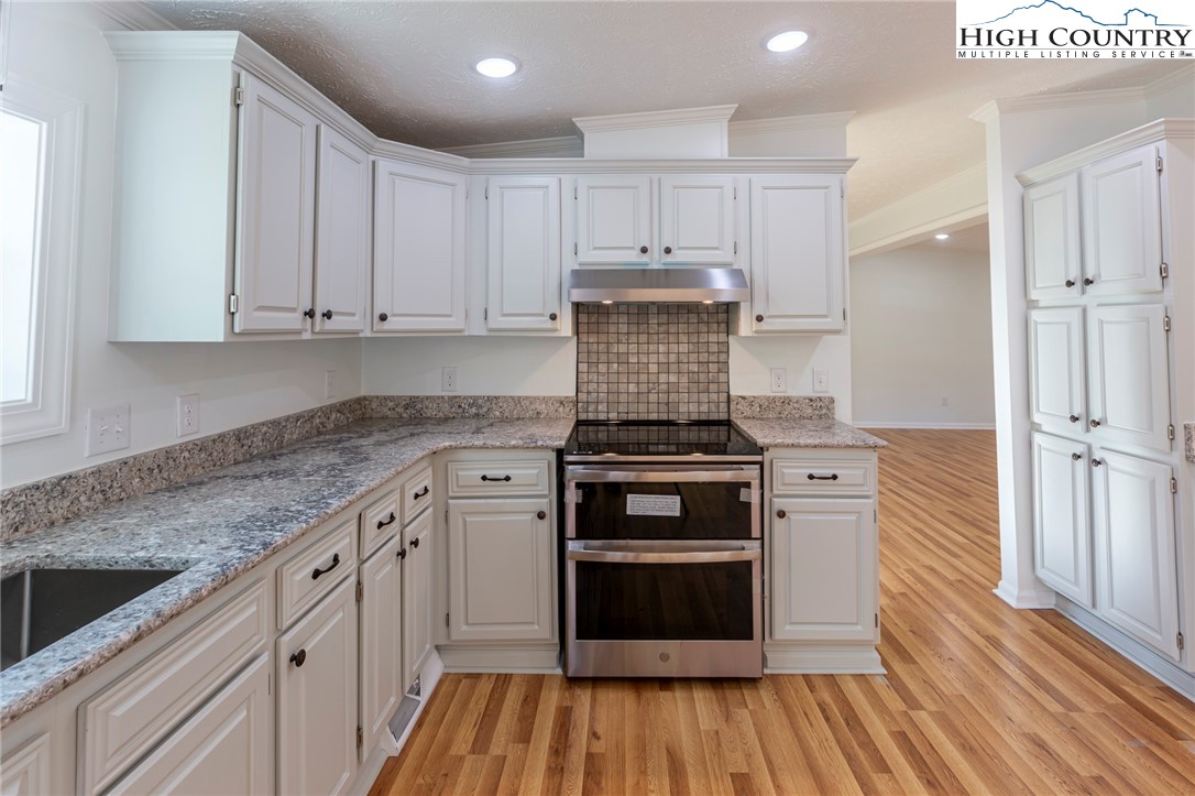 101 Beau Rivage Drive Crumpler, NC 28617 - Photo 17 of 47 a kitchen with stainless steel appliances granite countertop a stove and a refrigerator