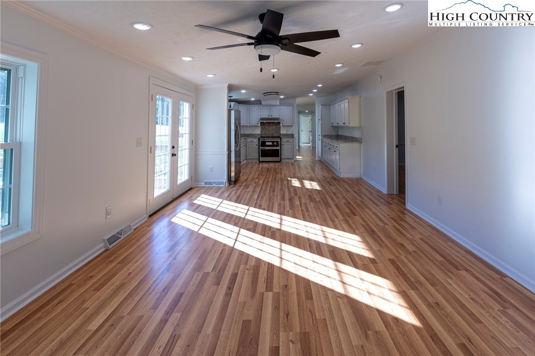 101 Beau Rivage Drive Crumpler, NC 28617 - Photo 19 of 47 a view of a living room a hallway and a kitchen with wooden floor
