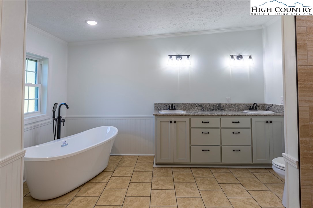 101 Beau Rivage Drive Crumpler, NC 28617 - Photo 22 of 47 a spacious bathroom with a granite countertop sink and mirror