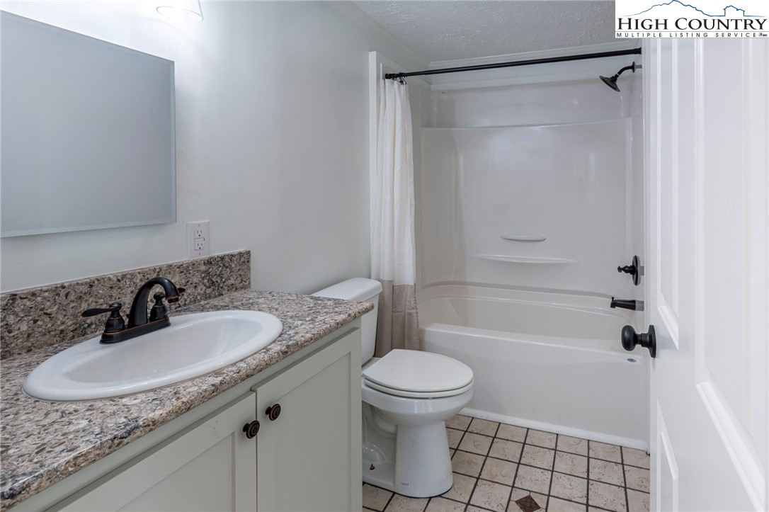 101 Beau Rivage Drive Crumpler, NC 28617 - Photo 30 of 47 a bathroom with a granite countertop sink toilet and shower