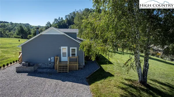 a backyard of a house with table and chairs