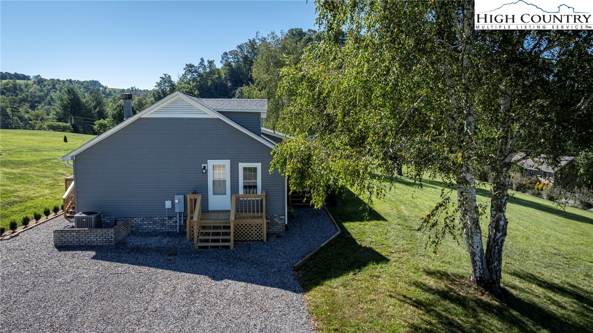 101 Beau Rivage Drive Crumpler, NC 28617 - Photo 3 of 47 a backyard of a house with table and chairs
