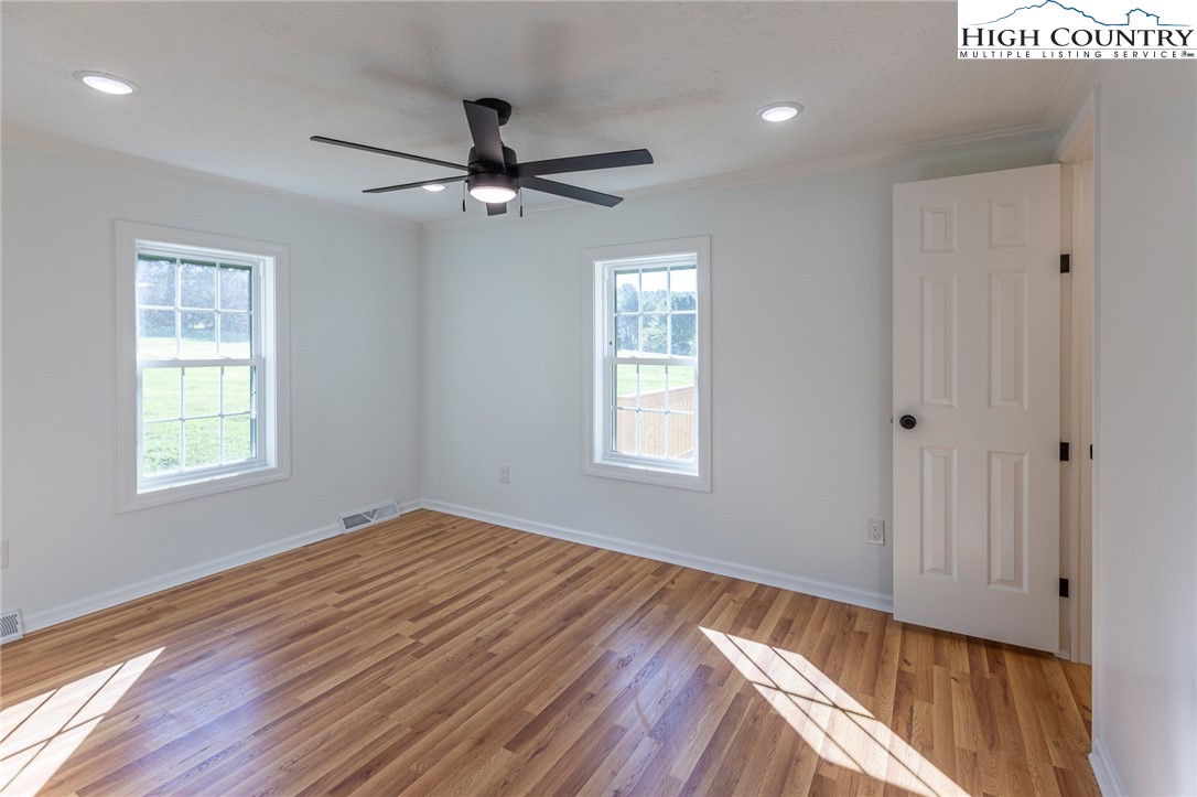 101 Beau Rivage Drive Crumpler, NC 28617 - Photo 32 of 47 a view of an empty room with wooden floor and a window