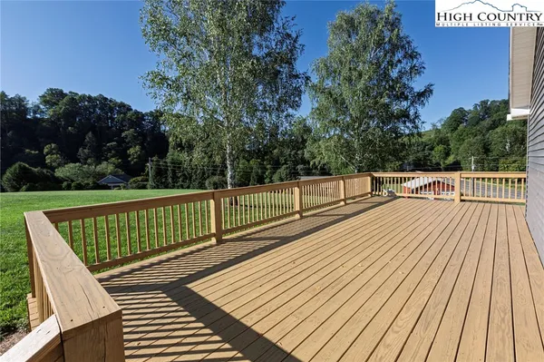 a view of balcony with wooden floor and fence