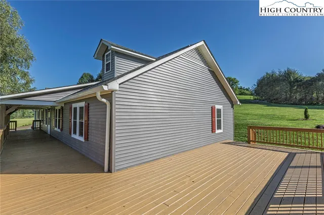 a view of a house with wooden deck