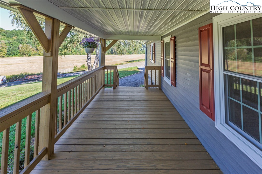 101 Beau Rivage Drive Crumpler, NC 28617 - Photo 5 of 47 a view of a porch with wooden floor and stairs