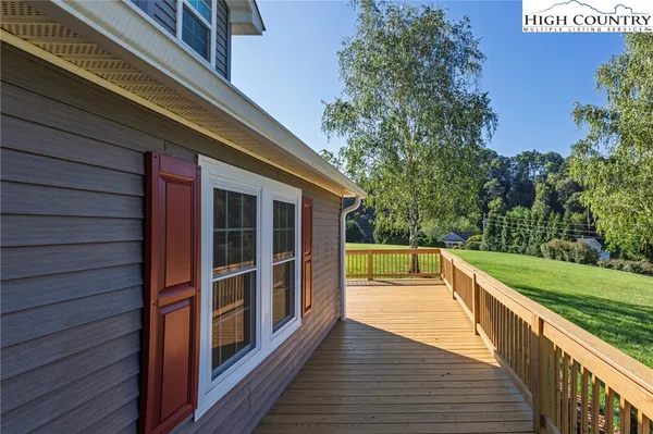 a view of a balcony with wooden floor and fence