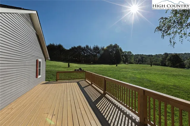 a view of a balcony with wooden floor and fence