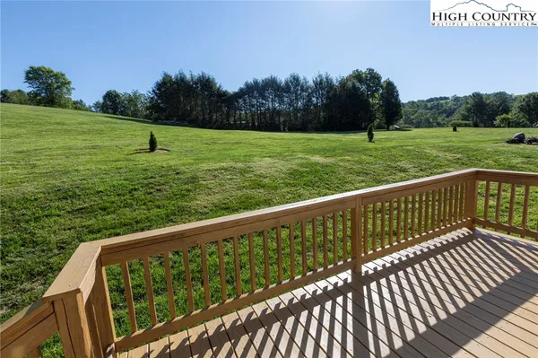 a view of a wooden deck with a yard