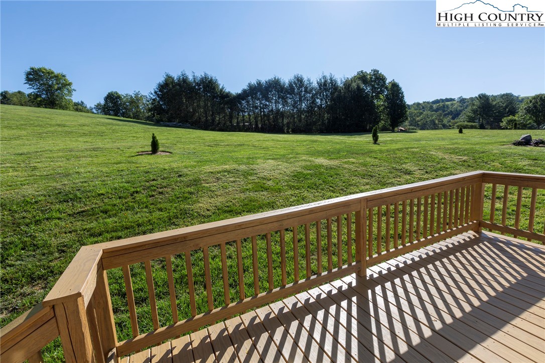 101 Beau Rivage Drive Crumpler, NC 28617 - Photo 9 of 47 a view of a wooden deck with a yard