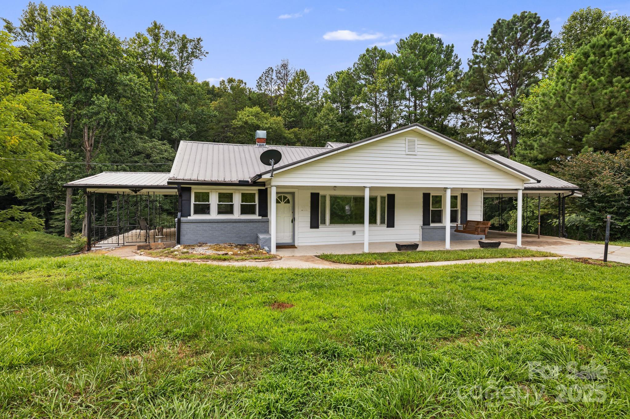 a front view of a house with swimming pool having outdoor seating