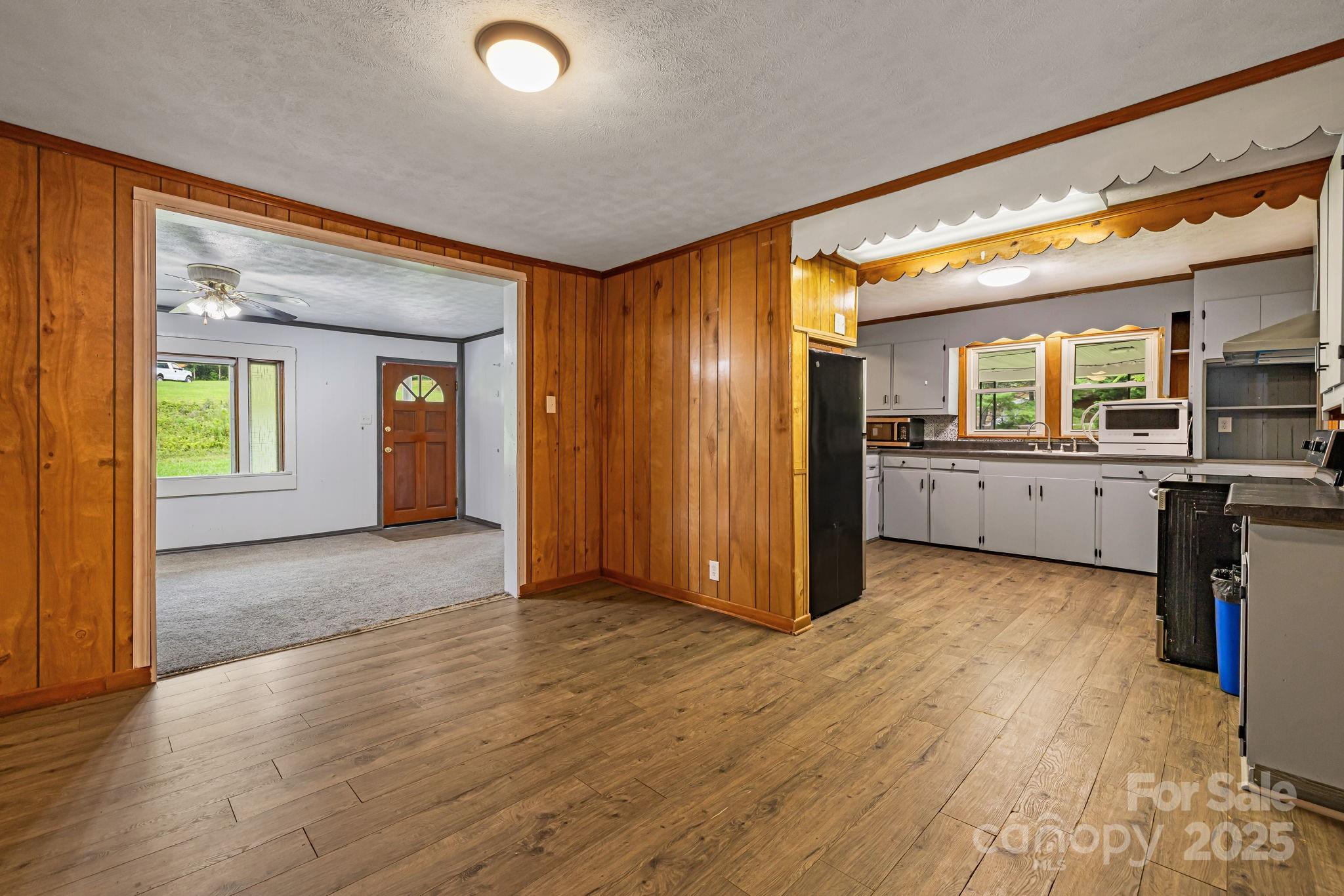 8171 Sugar Hill Road Marion, NC 28752 - Photo 12 of 27 a view of a big room with wooden floor and a kitchen