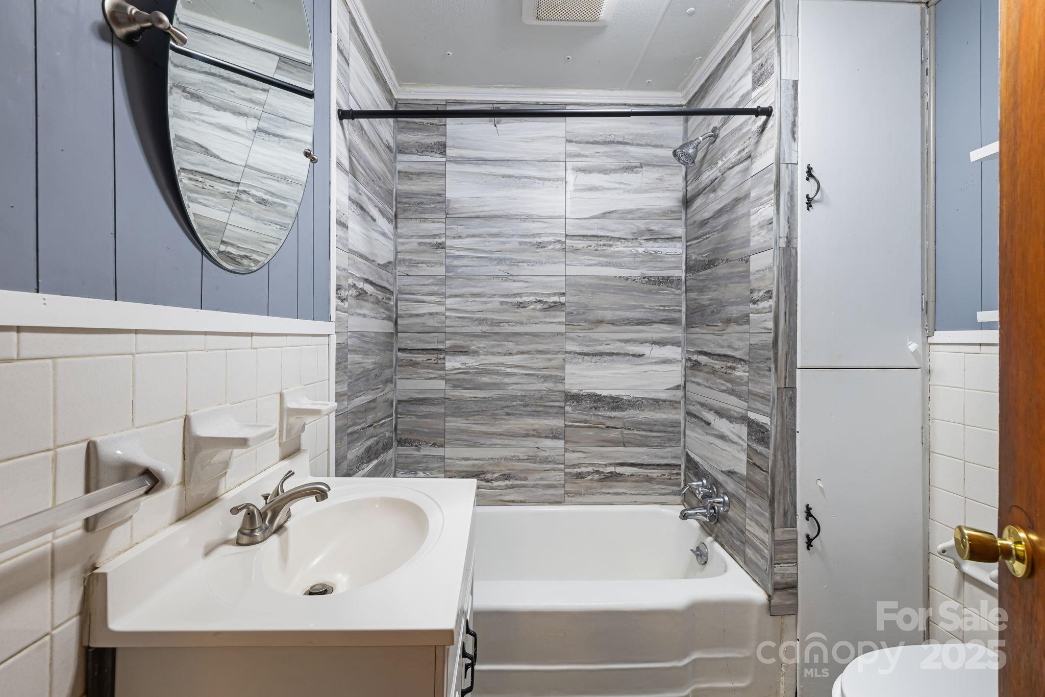 8171 Sugar Hill Road Marion, NC 28752 - Photo 15 of 27 a bathroom with a sink and a mirror