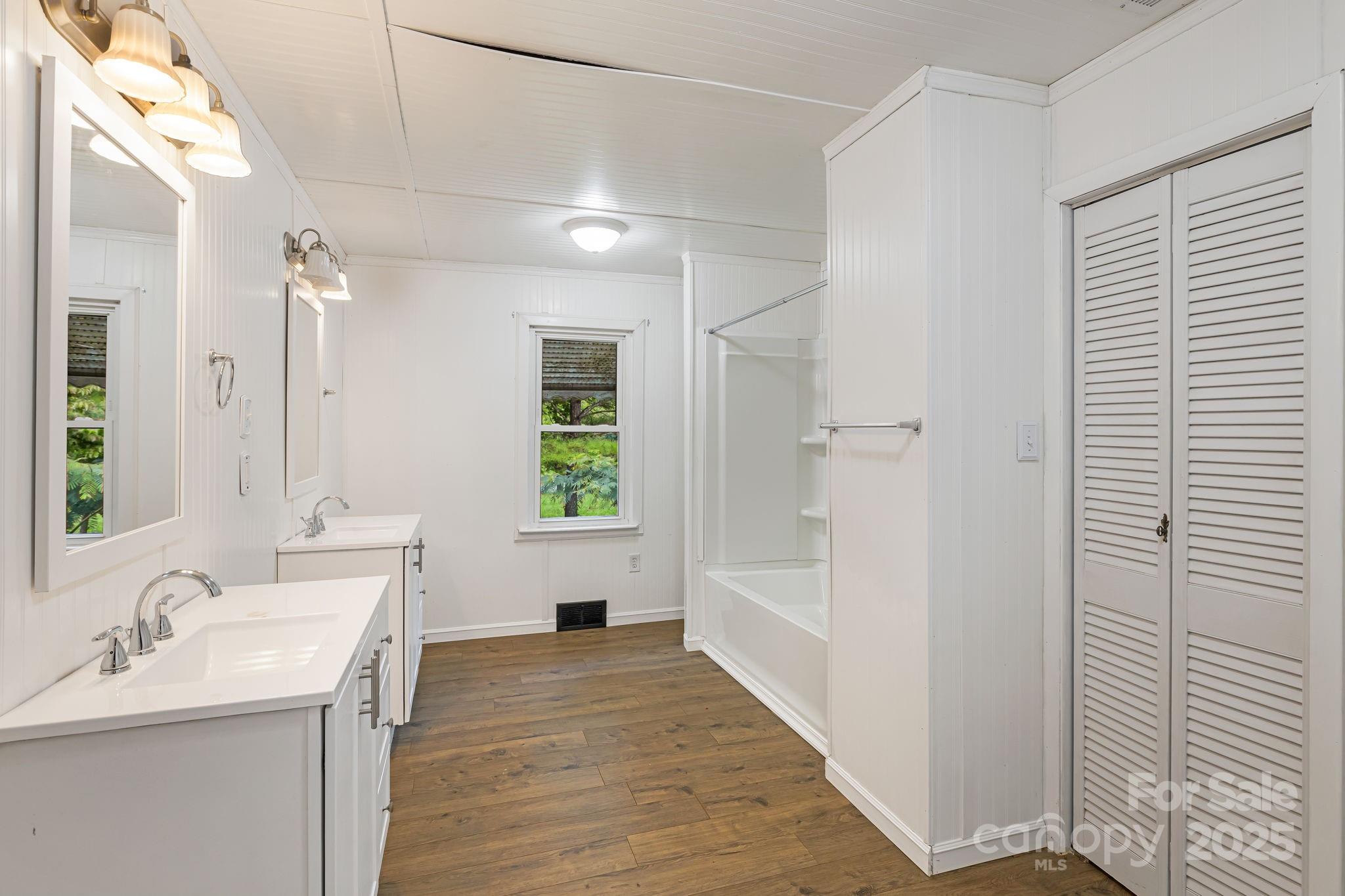 8171 Sugar Hill Road Marion, NC 28752 - Photo 20 of 27 a bathroom with a sink and a bathtub