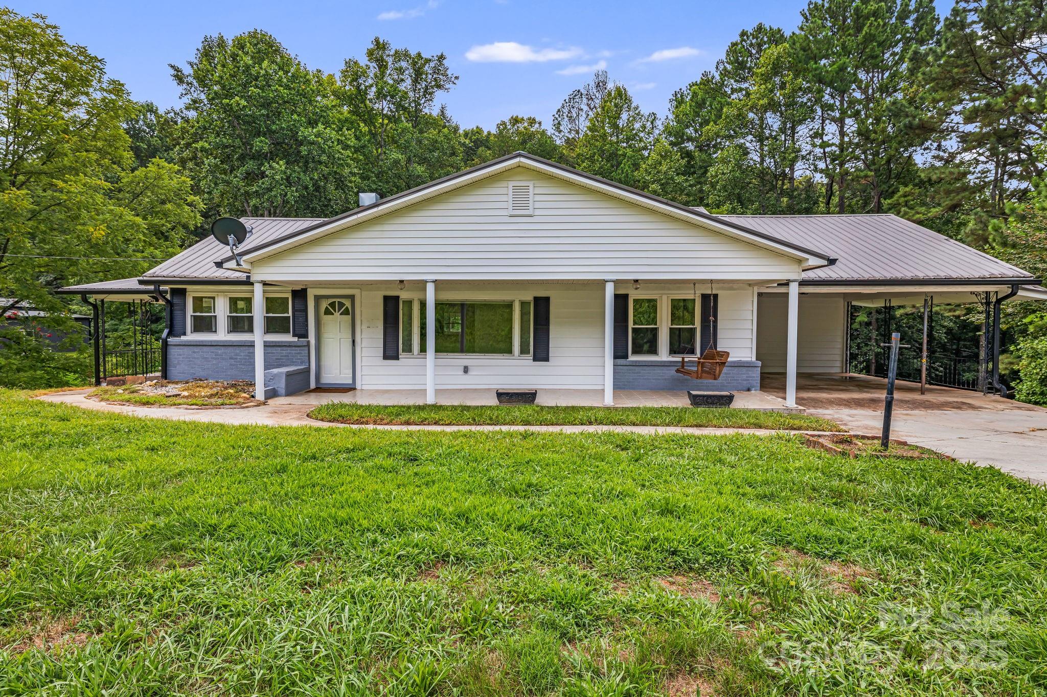 8171 Sugar Hill Road Marion, NC 28752 - Photo 2 of 27 a view of a house with a yard and sitting area