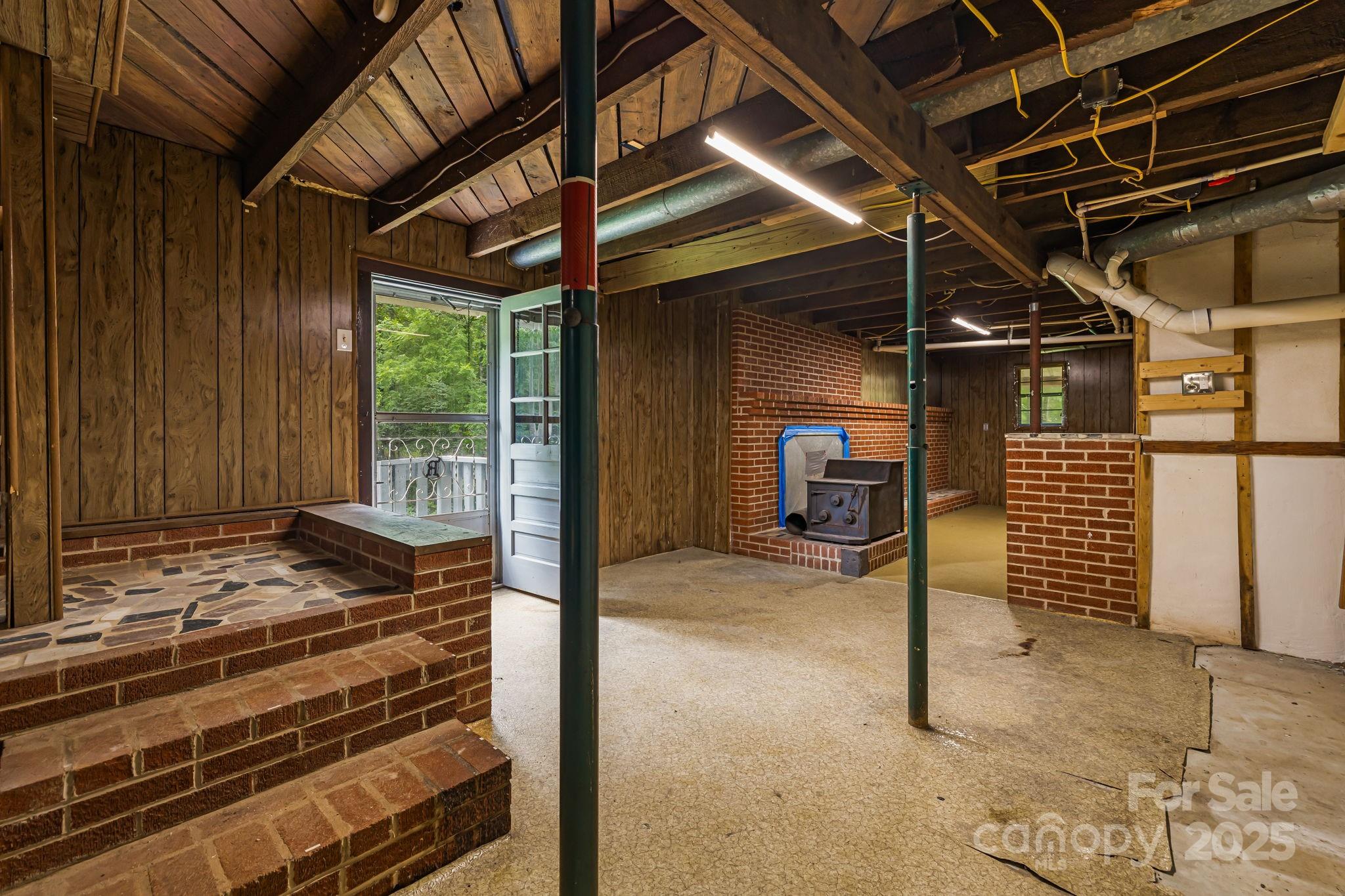 8171 Sugar Hill Road Marion, NC 28752 - Photo 22 of 27 a view of a room with wooden walls and iron stairs