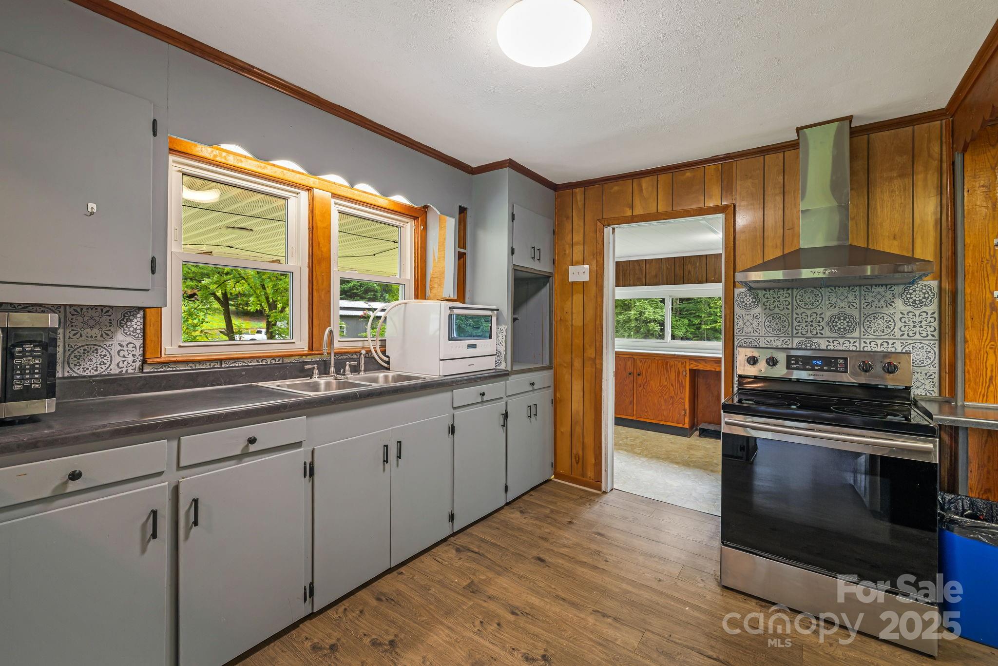 8171 Sugar Hill Road Marion, NC 28752 - Photo 5 of 27 a kitchen with granite countertop a stove and a sink