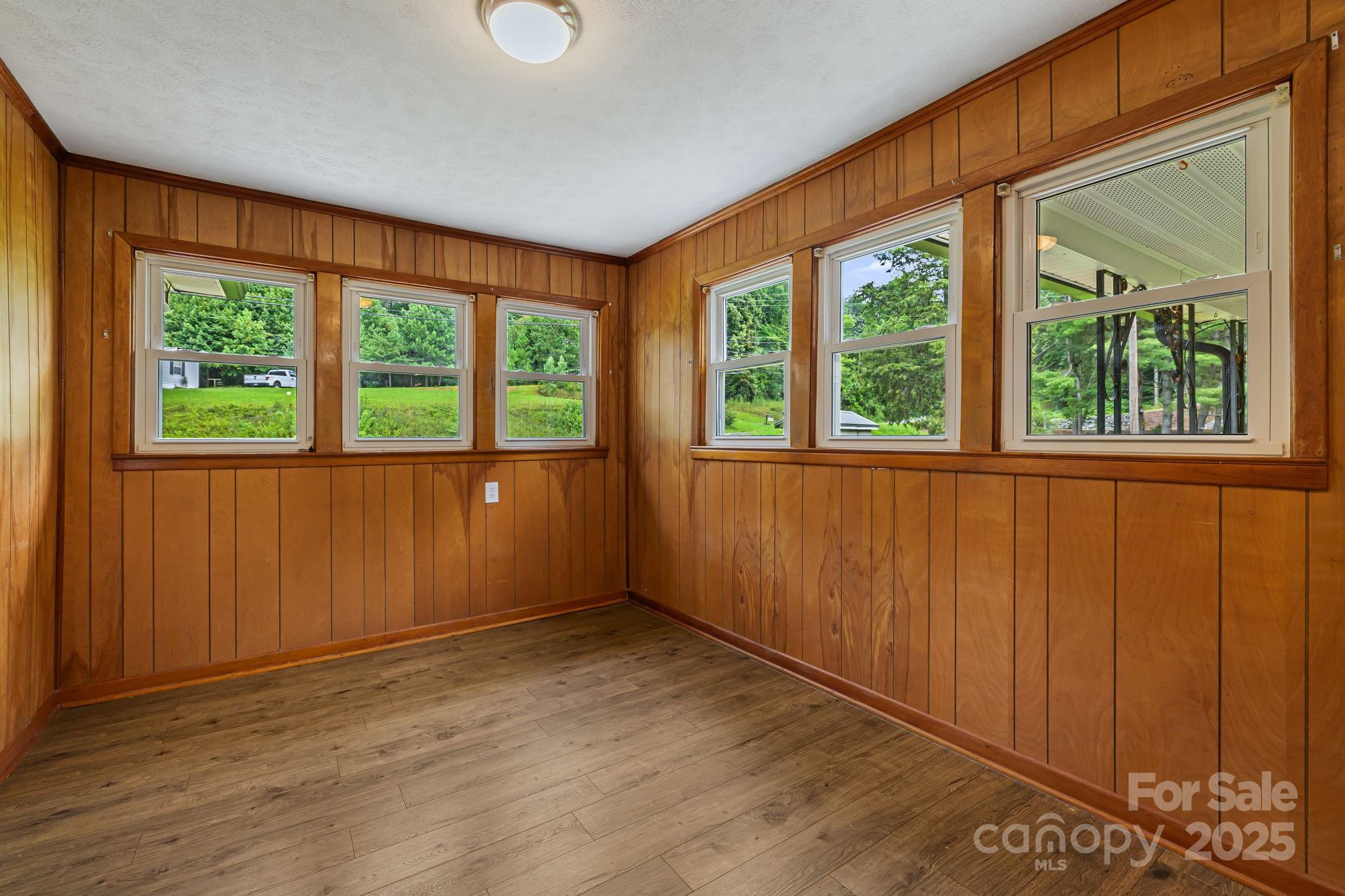 8171 Sugar Hill Road Marion, NC 28752 - Photo 6 of 27 an empty room with wooden floor and windows