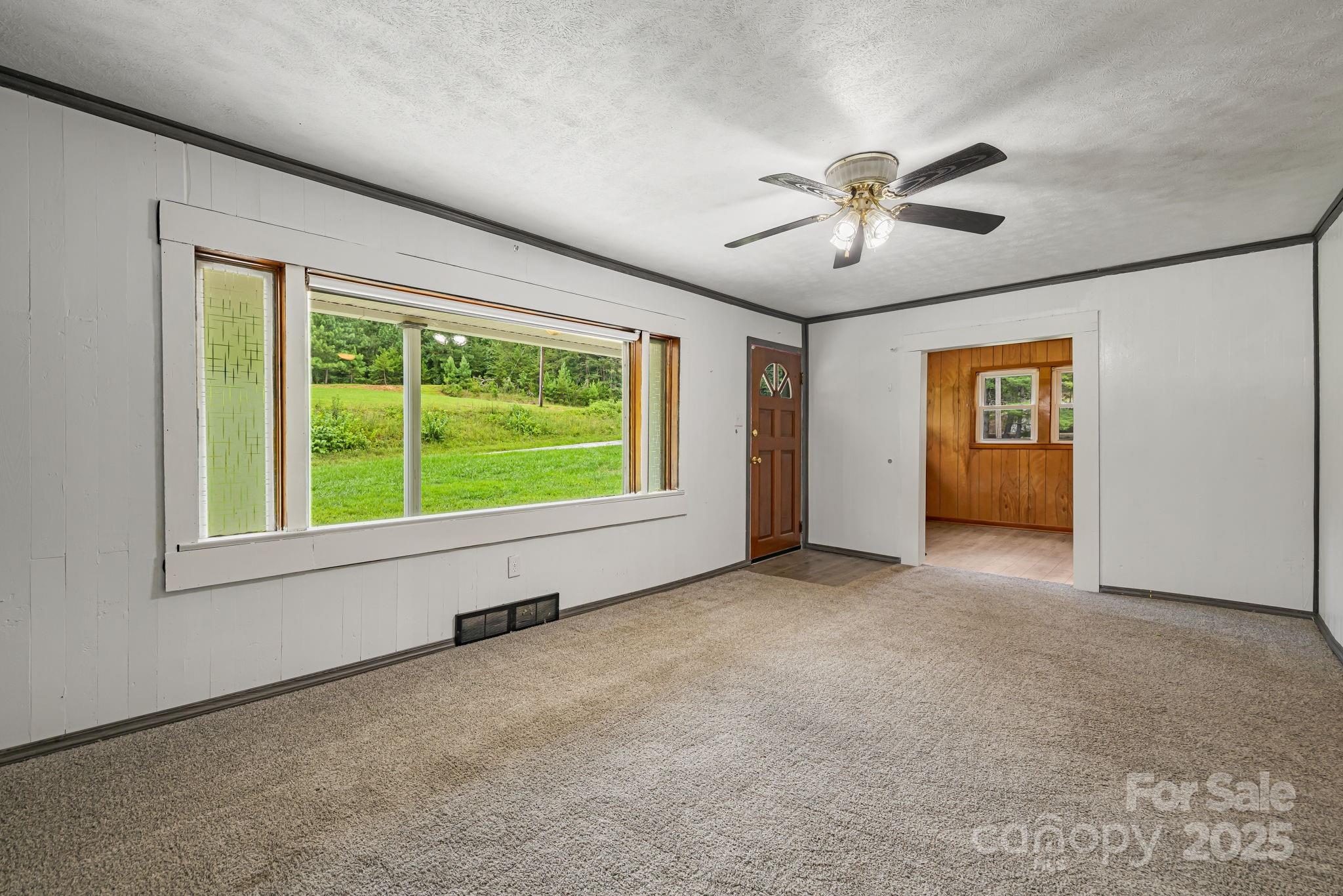 8171 Sugar Hill Road Marion, NC 28752 - Photo 10 of 27 a view of a livingroom with a ceiling fan and window