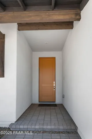 an empty room with wooden floor and a window
