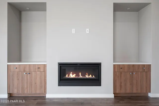 a view of a hallway with wooden floor and a fireplace