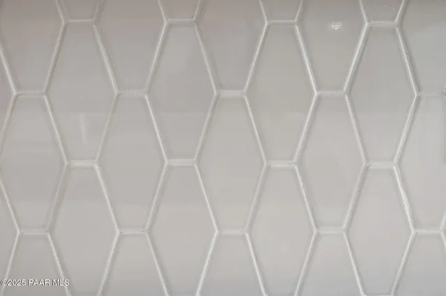 an empty room with wooden floor and hallway