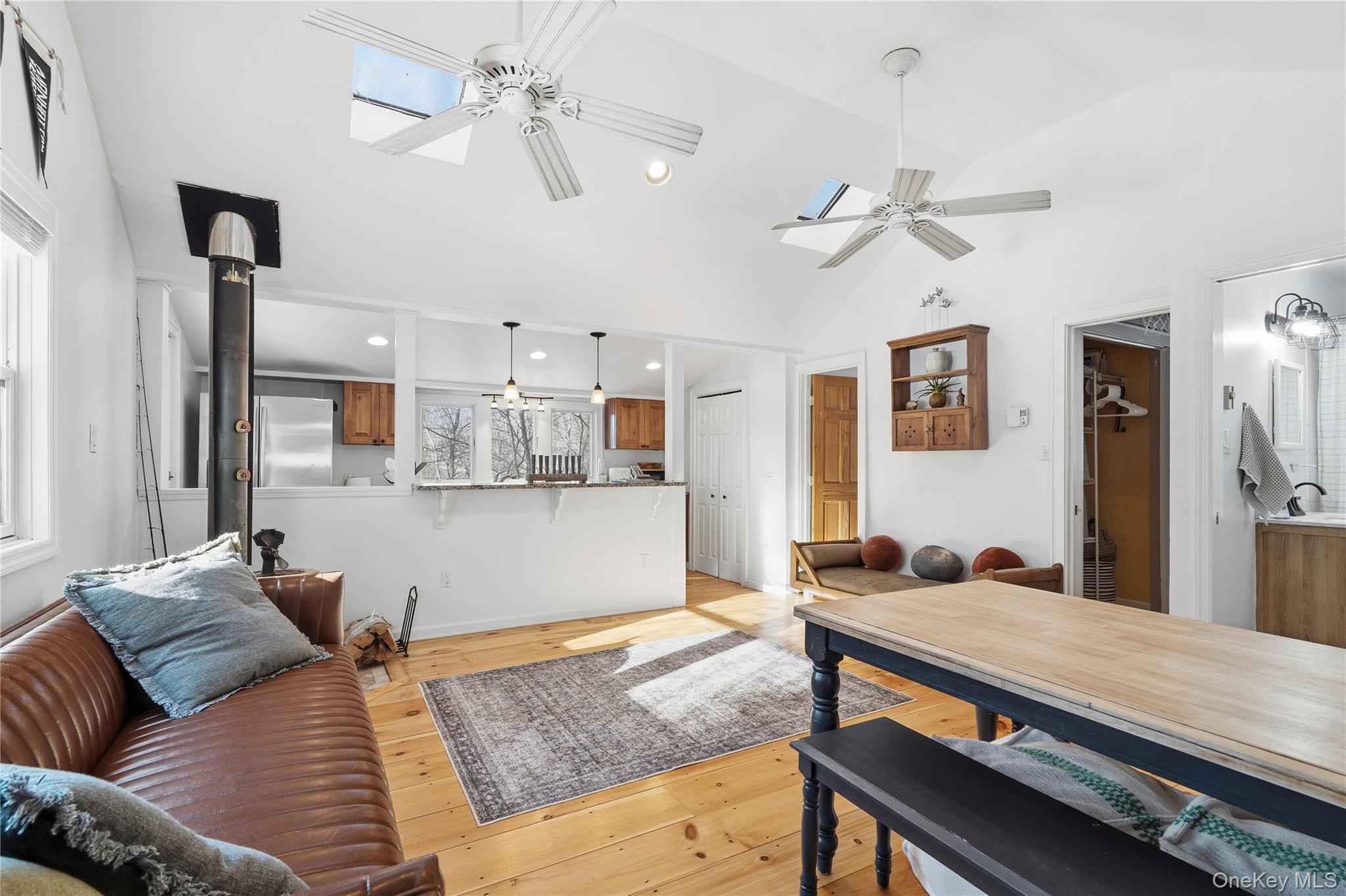 37 Sawmill Road Putnam Valley, NY 10579 - Photo 12 of 23 a living room with stainless steel appliances furniture a chandelier fan and a kitchen view