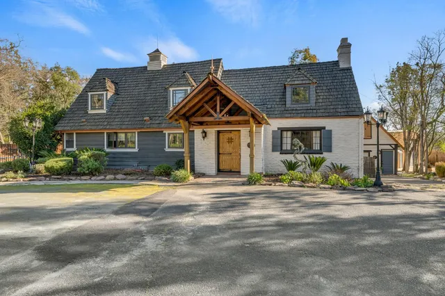 a front view of a house with a garden