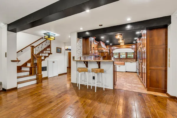 a view of a living room with wooden floor and furniture