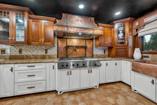 a kitchen with granite countertop a sink and cabinets