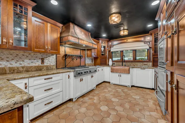 a kitchen with stainless steel appliances granite countertop a stove and a refrigerator