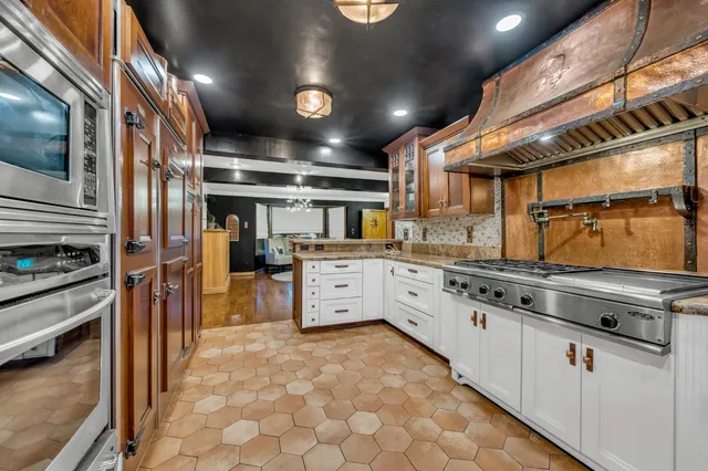 a kitchen with granite countertop stainless steel appliances and counter space