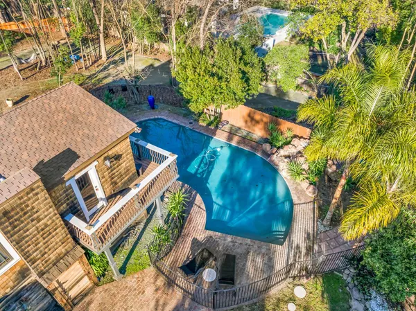 a view of a house with a yard and tree s