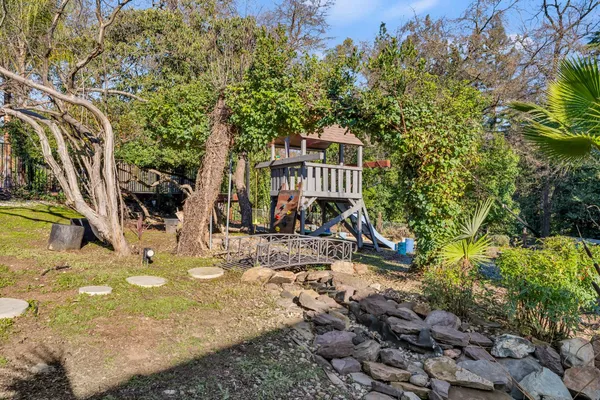 a view of a house with a yard and sitting area