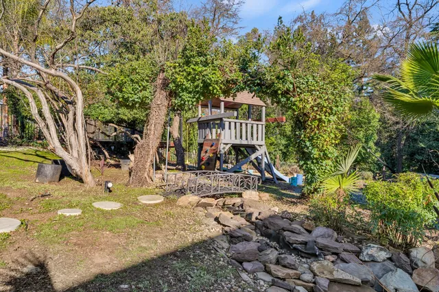 a view of a house with a yard and sitting area