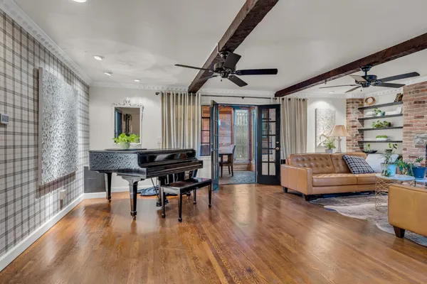 a living room with furniture and a wooden floor