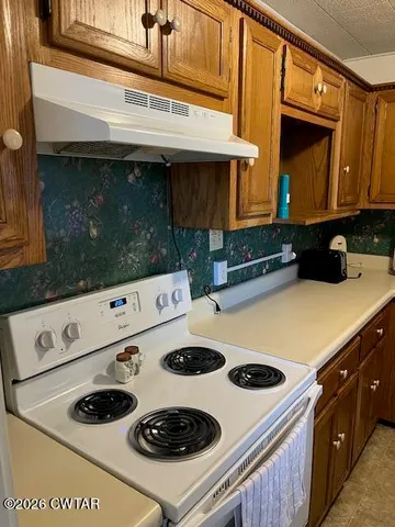 a kitchen with a stove and a microwave