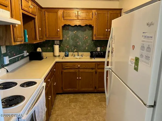 a kitchen with a refrigerator and a stove